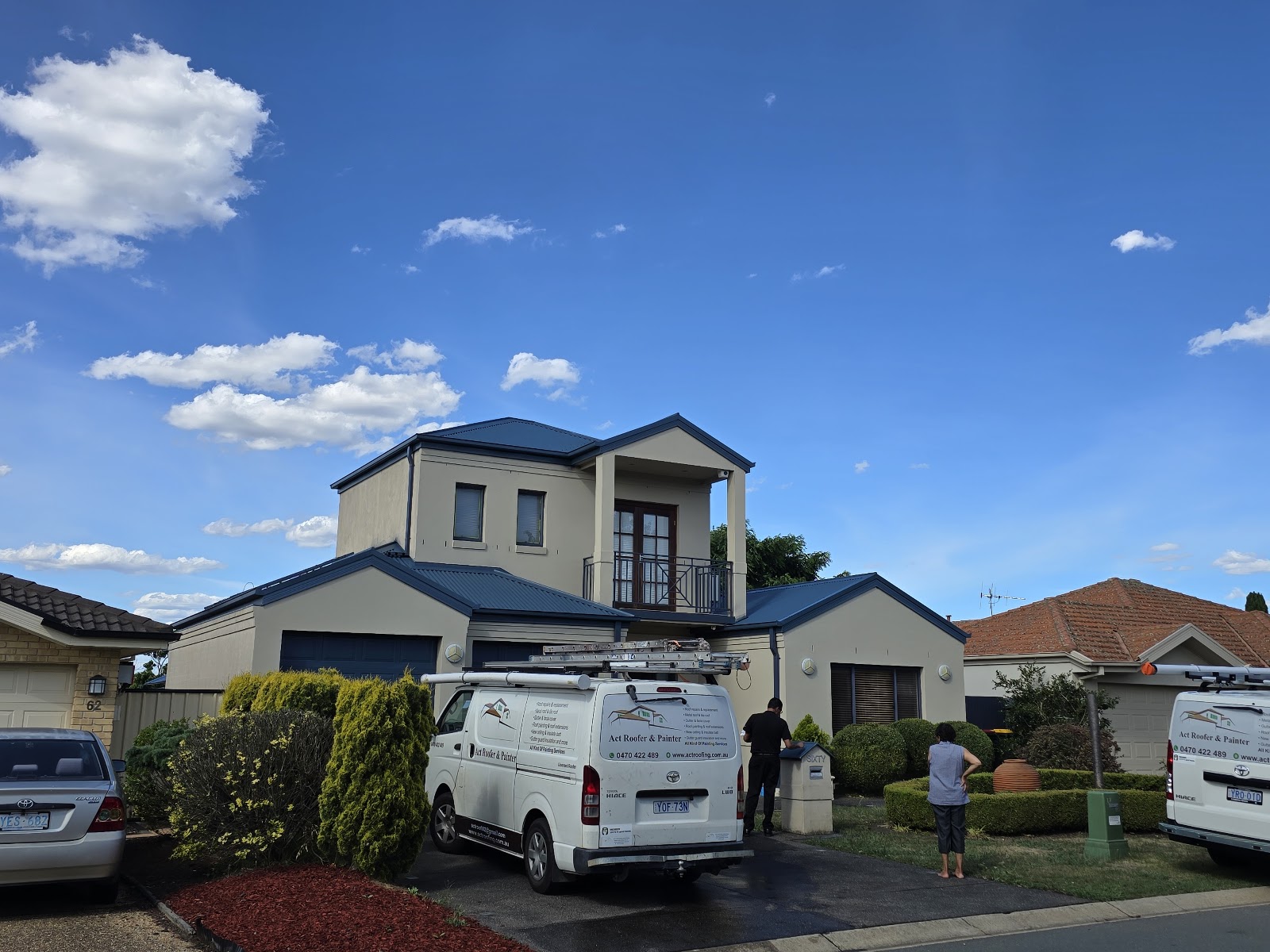 Two ACT Roofer and Painter vans parked out the front of a Canberra home on a job